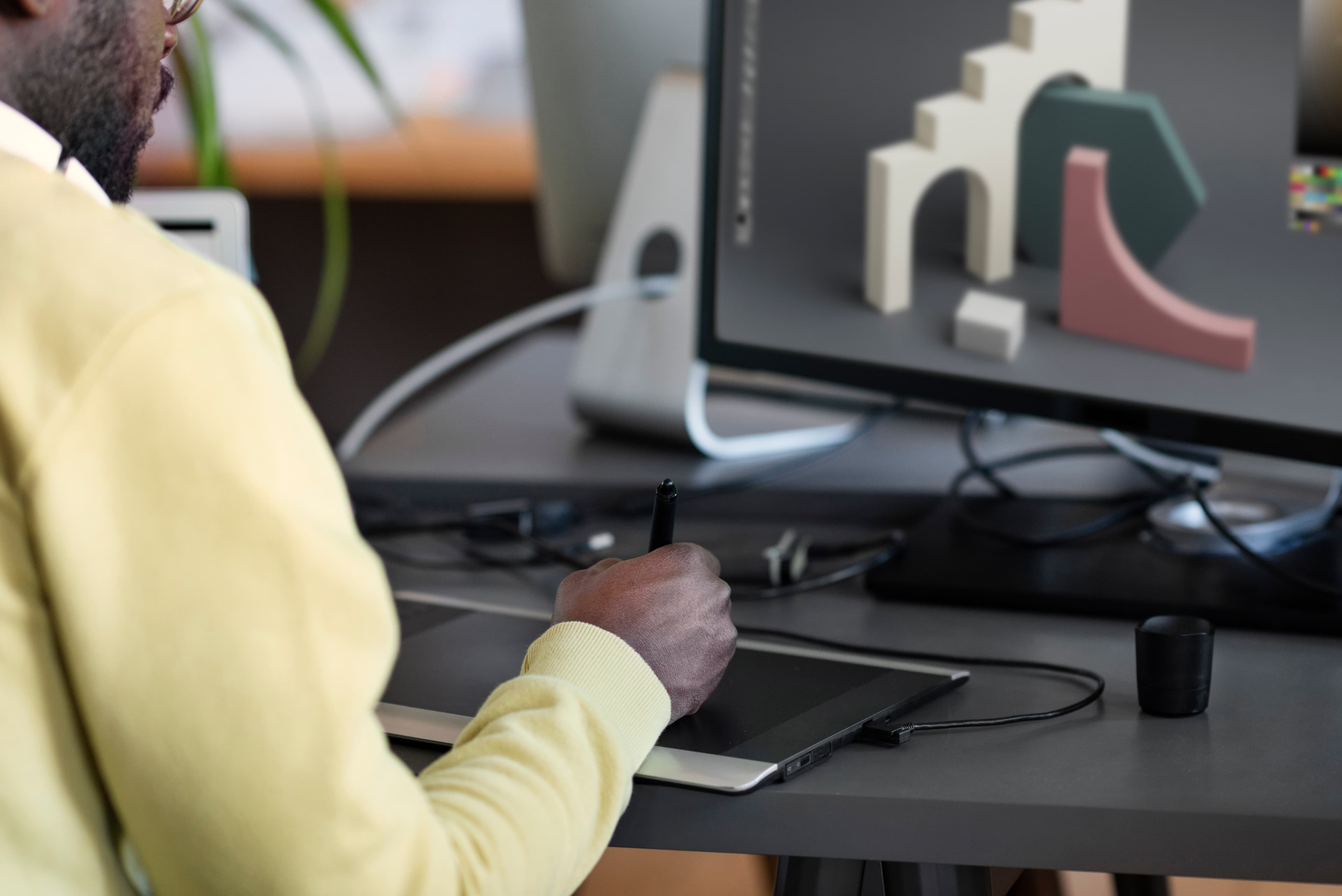 Designer working on artwork at a studio desk